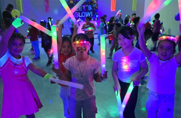  group of kids smiling with glow lights